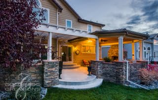 Covered Patio Retreat with Flatstone Accents and Outdoor Kitchen