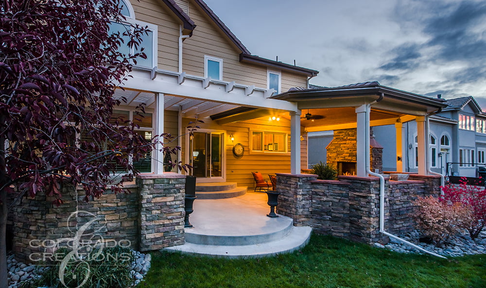 Covered Patio Retreat with Flatstone Accents and Outdoor Kitchen